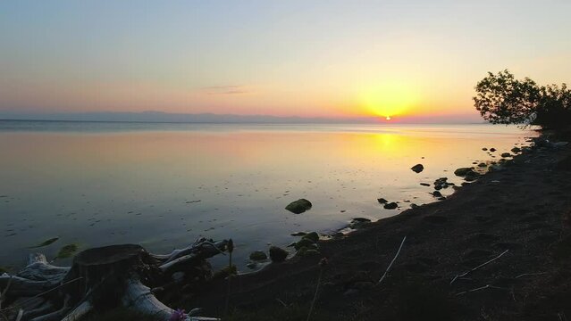 Scenic sunset over lake horizon panorama time-lapse outdoors with photographer shooting