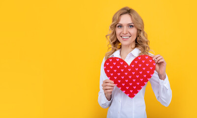 glad woman with red love heart on yellow background