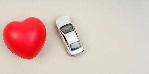 On the gray surface are the heart and the car model.