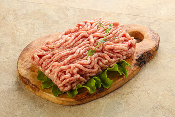 Raw minced pork meat over board