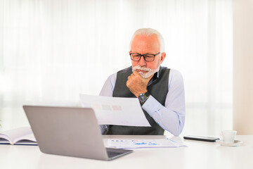 Fototapeta na wymiar Older man worried about business forecast for this year