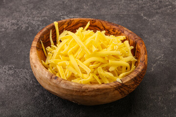 Shredded yellow cheese in the bowl