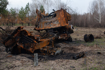 Burnt out military vehicle, after being hit by a shell