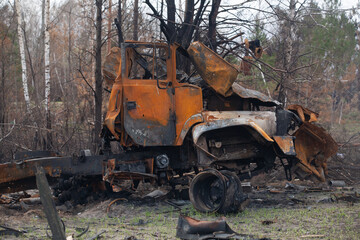 Burnt out military vehicle, after being hit by a shell