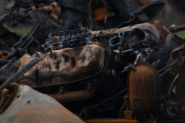 burned out car engine after being hit by a bullet