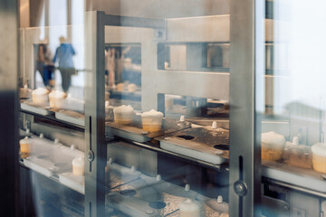 Manufacturin for automatic production of ice cream cones. Conveyor belt in waffle cups, creme brulee. Sweets modern factory. Food dairy industry, automated technology equipment and engineering concept