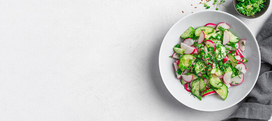 Summer, healthy salad with radishes, micro greens, cucumber and flax seeds. Top view, horizontal.