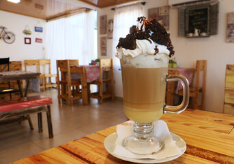 Cappuccino with chocolate and cream in a cafe
