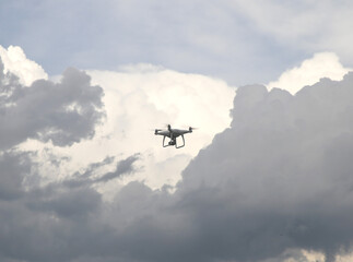 Fototapeta na wymiar White drone flying in the sky