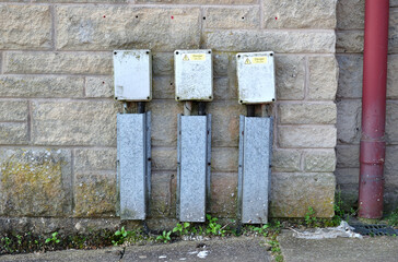 Close Up of Three Identical Electrical Outlets on Stone Wall 