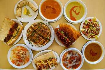 Traditional Turkish cuisine. Pizza, pita, pidesi, sucuk, hummus, kebab. Many dishes on the table. Serving dishes in restaurant. Background image. Top view, flat lay