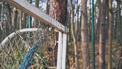Neglected Abandoned Soccer Field Football Gate with Torn Entangled Net © rohawk