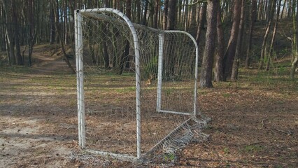 Neglected Abandoned Soccer Field Football Gate with Torn Entangled Net