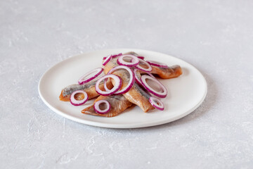 Pieces of hering decorated with the red onions