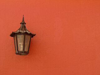 Colonial lamp on a peachy orange colored wall in Old san Juan Puerto Rico