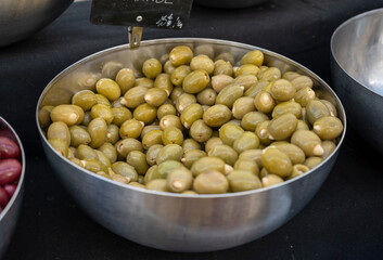 Green ItalianBrown olives stuffed with garlic for sale on farmers market