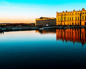 versailles castle in france at sunset with lake in frontersailles castle in france at sunset with...