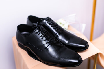 Groom's black wedding shoes close up
