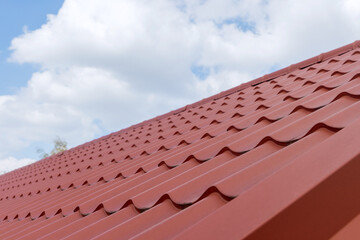 Modern roof with effect coated red metal covered roof tile