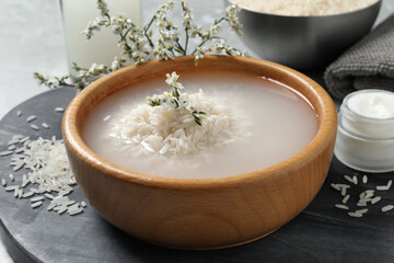 Bowl with soaked rice on table, closeup