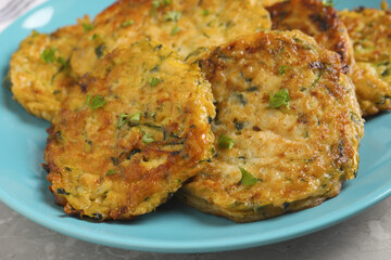 Delicious zucchini pancakes on grey table, closeup