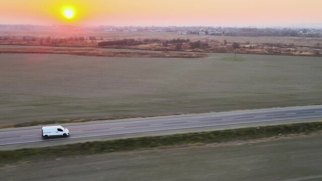 Aerial view of cargo van driving on highway hauling goods. Delivery transportation and logistics concept