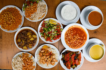 Traditional Turkish cuisine. Pizza, pita, pidesi, sucuk, hummus, kebab. Many dishes on the table. Serving dishes in restaurant. Background image. Top view, flat lay