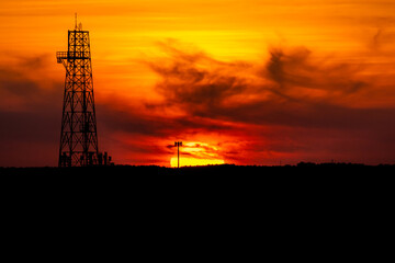 oil refinery at sunset
