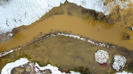 Snow melts in springtime in rural wisconsin flooding the area