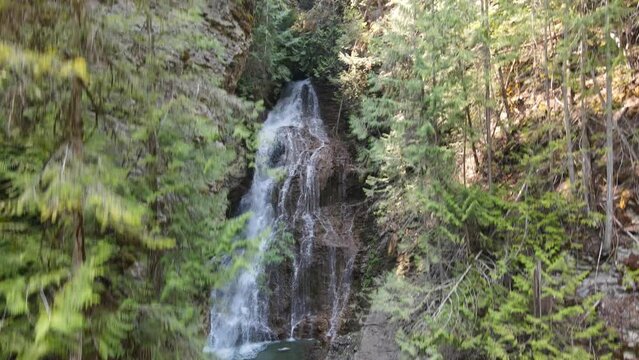 Stunning Margaret Falls cascading down a forest mountain in the popular Herald Provincial Park in British Columbia, Canada. Aerial trucking shot 