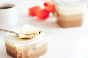 Puffed bird's milk of three types in plastic containers with spoon.