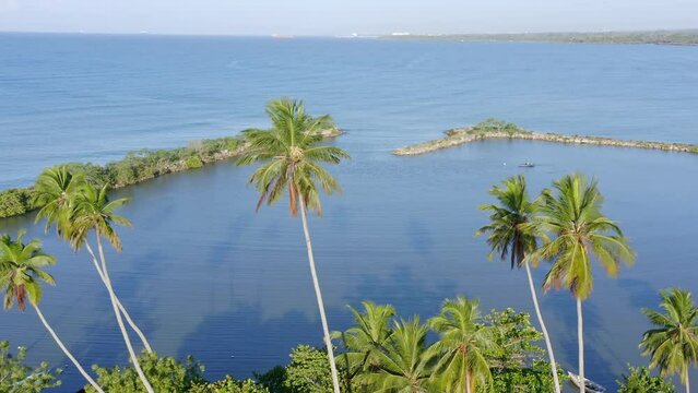 Fisherman on small boat at Soco river mouth, Dominican Republic. Aerial drone view