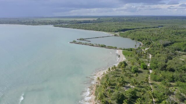 Soco river mouth and surrounding landscape in Dominican Republic. Aerial forward