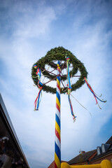  colorfully decorated maypole in nice weather and the sky is blue