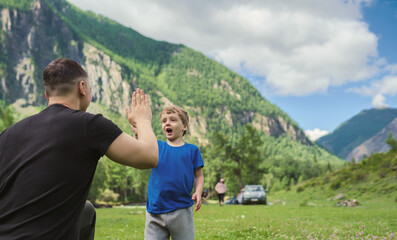 Fototapeta na wymiar Father and son having fun in the mountains