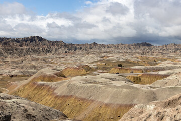 The colors of the sedimentary rocks at Badlands National Park in South Dakota pop against the blue skies