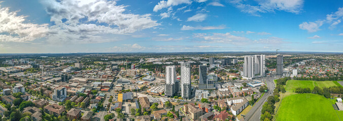 Fototapeta premium Panoramic aerial drone view of Liverpool in Greater Western Sydney, New South Wales, Australia looking east showing the high rise residential apartments