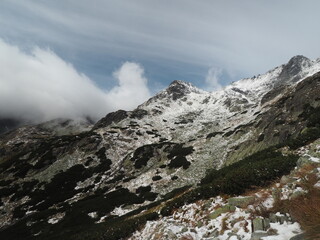 beautiful snow caped mountain peak in in the Slovak Tatras on a cloudy day.