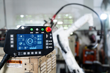 Robotic arm and its controller adept panel in a factory workshop . Industry robot programming...