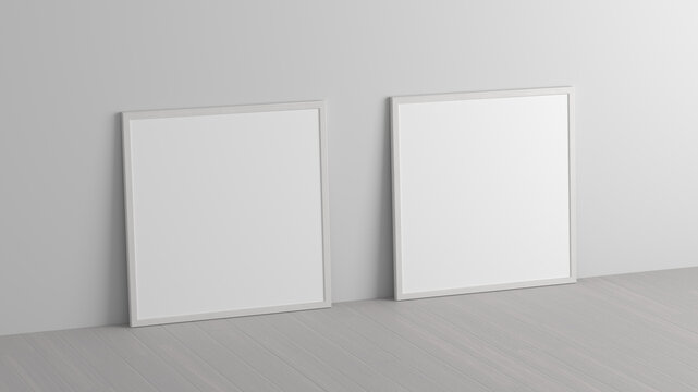 Mock up of two square frames on the floor in white interior.
