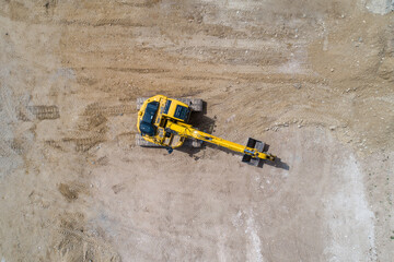 excavator working at a site digging the ground