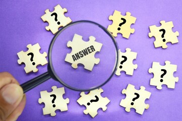 Puzzles and magnifying glasses, questions and answers. the concept of finding answers.