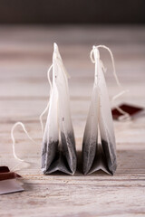 two tea bags on a white wooden table