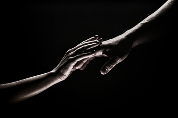 Two hands at the moment of farewell. The holding hands of relations. Help friend through a tough time. Rescue gesture, support, friendship and salvation concept. Man and woman holding hands.