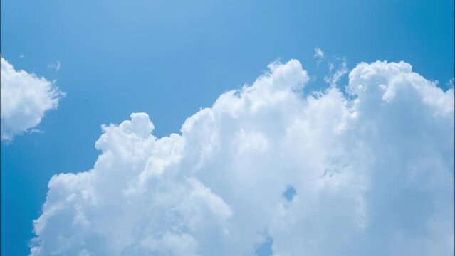 Time lapse of the blue sky in summer day. Blue sky white clouds. White clouds background.