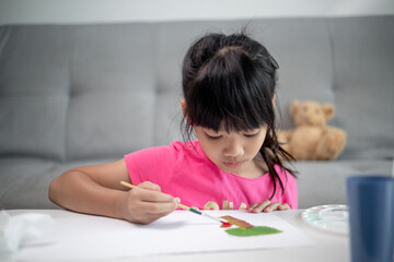 Girl Painting Picture On Table At Home