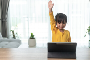 Asian little girl taking class on line and happy for Homeschool Quarantine coranavirus pandemic concept