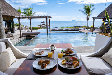 breakfast at a beach with palm trees and a pool in Mauritius, a tropical setting with breakfast.
