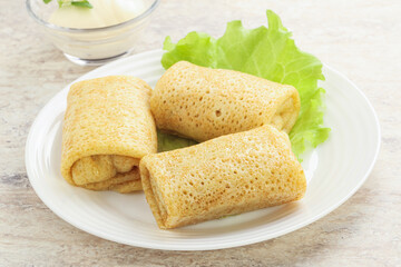 Stuffed pancakes with meat and cream