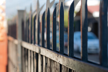 iron spikes of a security fence. gate of a house with its iron spikes to prevent theft - obrazy, fototapety, plakaty